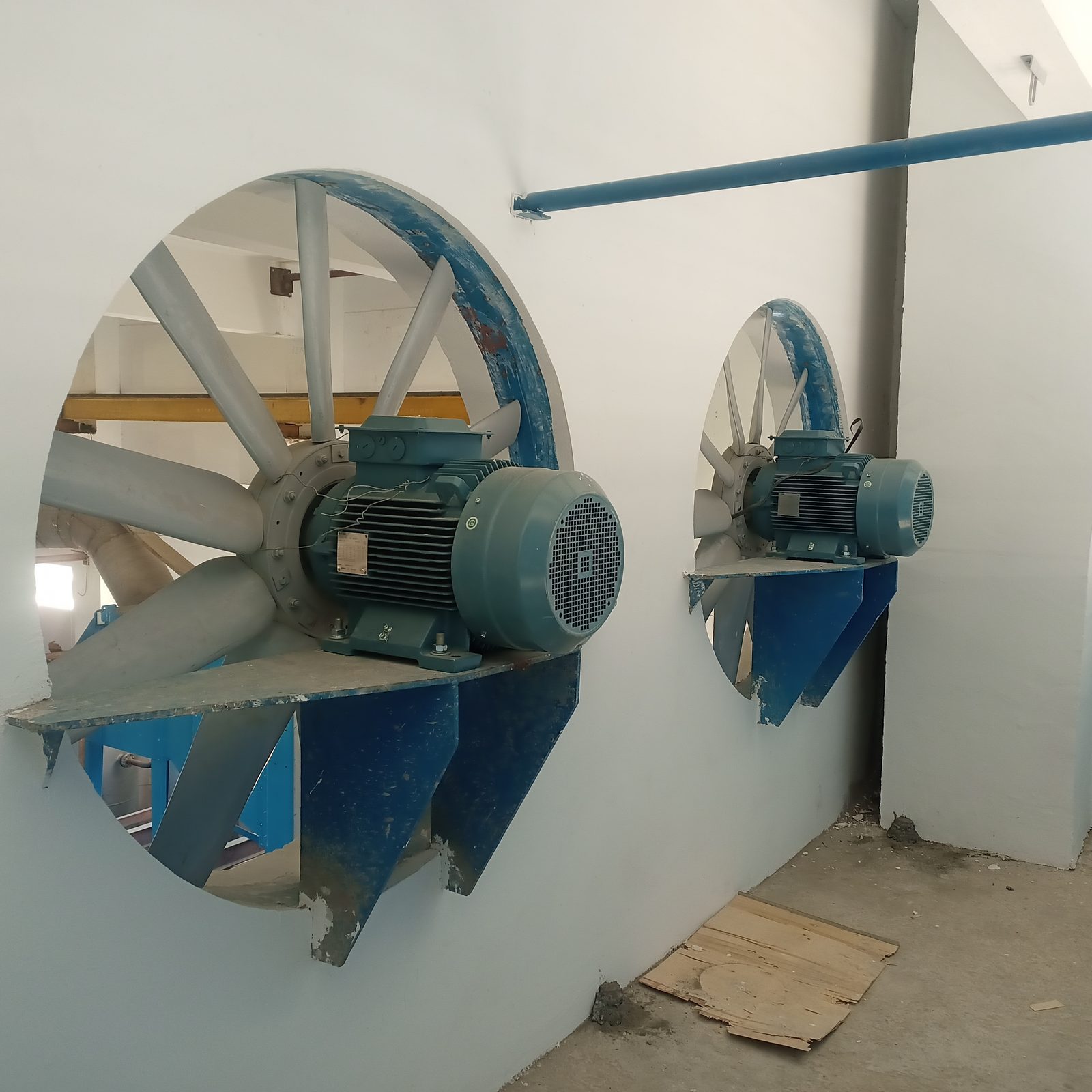 Axial fans mounted on factory wall